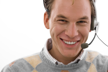 Smiling male customer service operator in headset, white background.